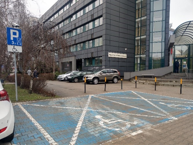 Zdjęcie miejsc parkingowych przed wejściem głównym